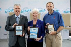 Arkansas Blue Cross and Blue Shield President and CEO Curtis Barnett , left, Arkansas Department of Human Services Director Cindy Gillespie and Arkansas Department of Health Director Nathaniel Smith during the Blue & You Fitness Challenge awards ceremony July 5, 2018 in Little Rock.