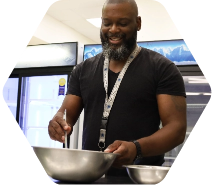 Antonio mixing something in a silver bowl
